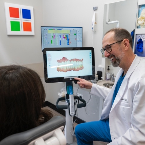 Man brushing his teeth after receiving a tooth colored filling