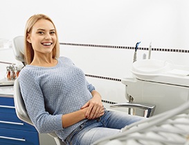 Blonde woman smiling while sitting in the dental chair