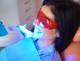 Woman smiling during in-office teeth whitening in Arlington Heights