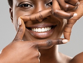 Woman framing her white teeth and beautiful smile