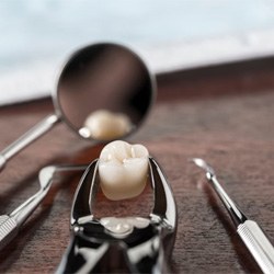 a wisdom tooth surrounded by dental tools on a table
