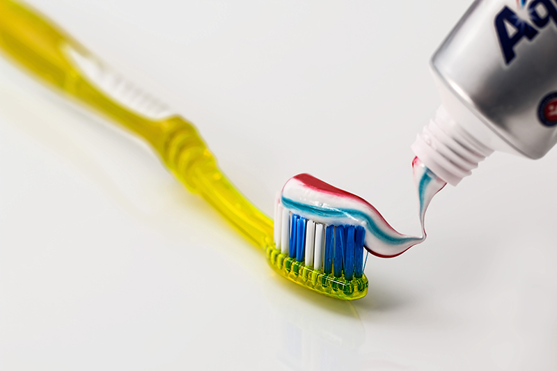 Toothpaste being applied to a toothbrush 
