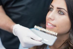 woman smiling, porcelain veneers, woman at dentist 