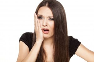  woman with dental pain, tooth pain, tooth sensitivity