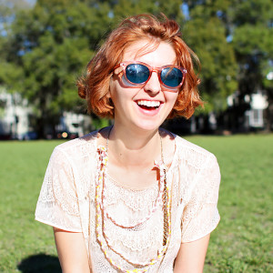 girl wearing sunglasses and smiling