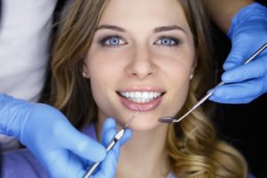Woman smiling in dental chair at dentist in Arlington Heights