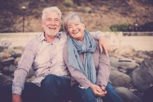 Older couple smiling after using tips for dentistry for seniors