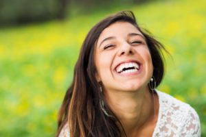 Woman smiling after seeing the dentist in Arlington Heights