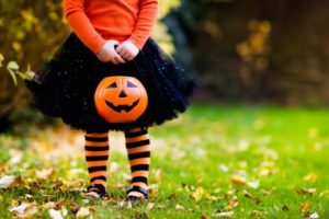 Little girl trick or treating while avoiding cavities after Halloween