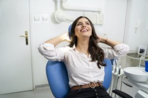 Woman who beat dental anxiety relaxing in dental chair