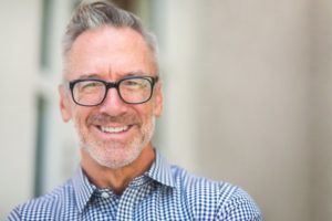 Man smiling after understanding the types of dental insurance