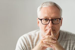 Older man thinking about dental implants