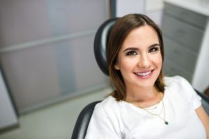 Woman smiling during her appointment with a family dentist