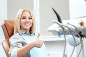 Woman smiling in the dental chair during her visit