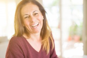 Woman smiling while sitting in the dental chair