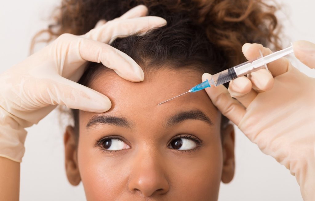 Closeup of woman wondering while getting BOTOX