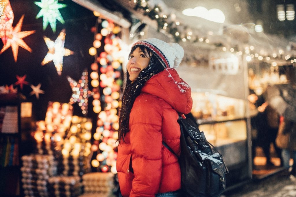 Closeup of woman smiling while shopping in the snow