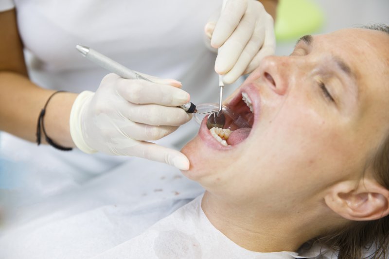 person being checked for gum disease