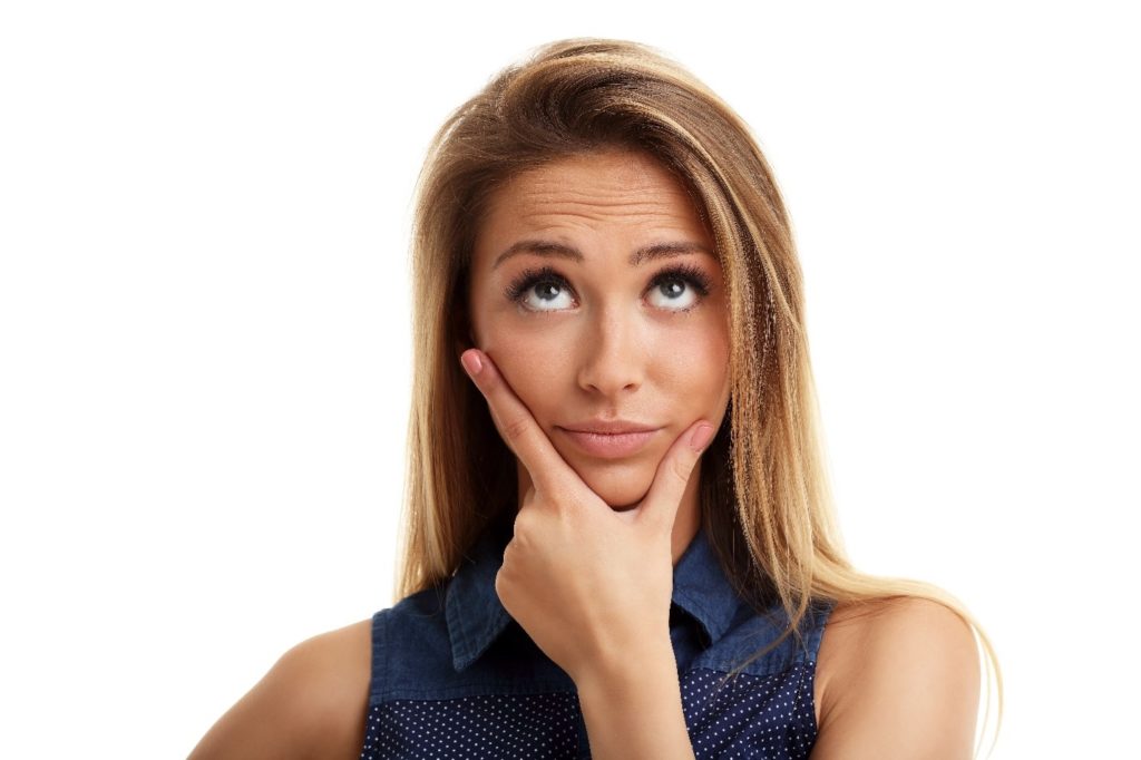 Closeup of woman in blue shirt wondering