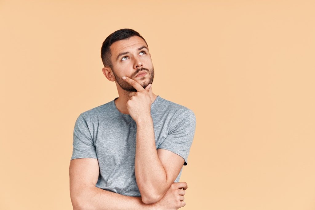 Closeup of man in gray shirt wondering