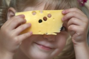 little girl eating Swiss cheese 