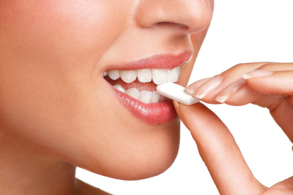 Closeup of woman biting into a piece of gum