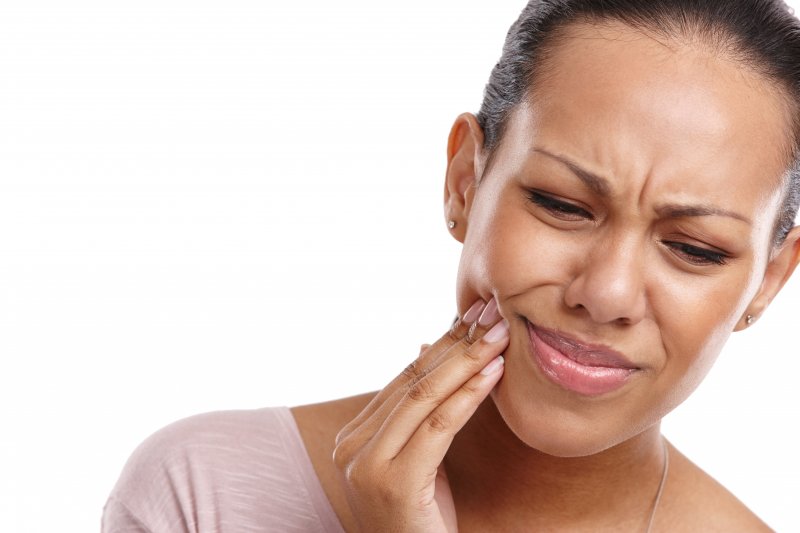 a woman experiencing issues with impacted wisdom teeth