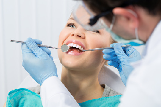 patient smiling at dentist during checkup 