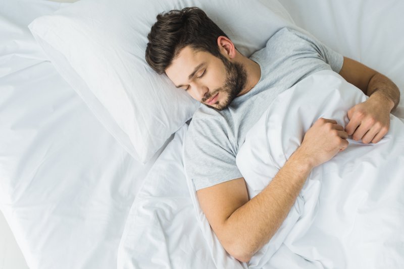 a man sleeping after undergoing wisdom tooth extractions