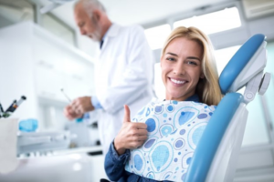 a patient visiting their dentist and smiling 