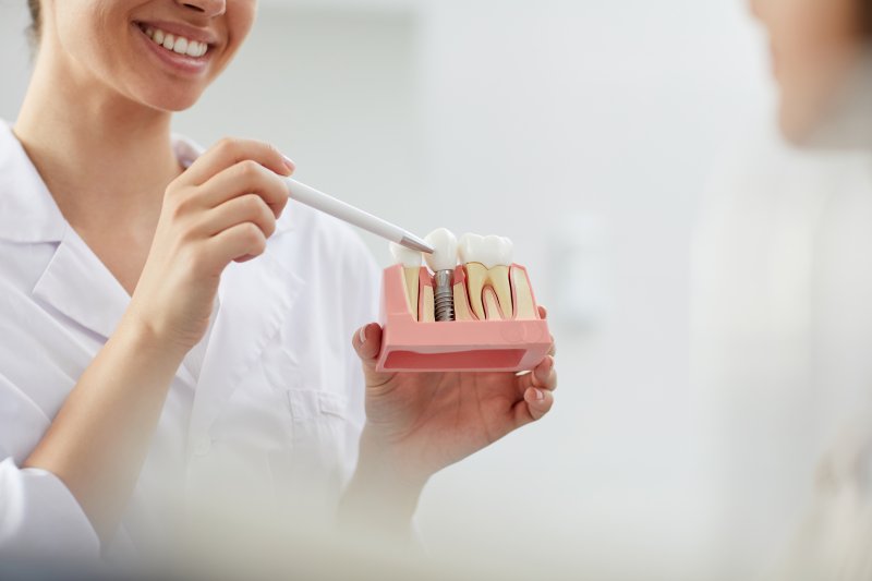 dentist talking to patient about dental implants
