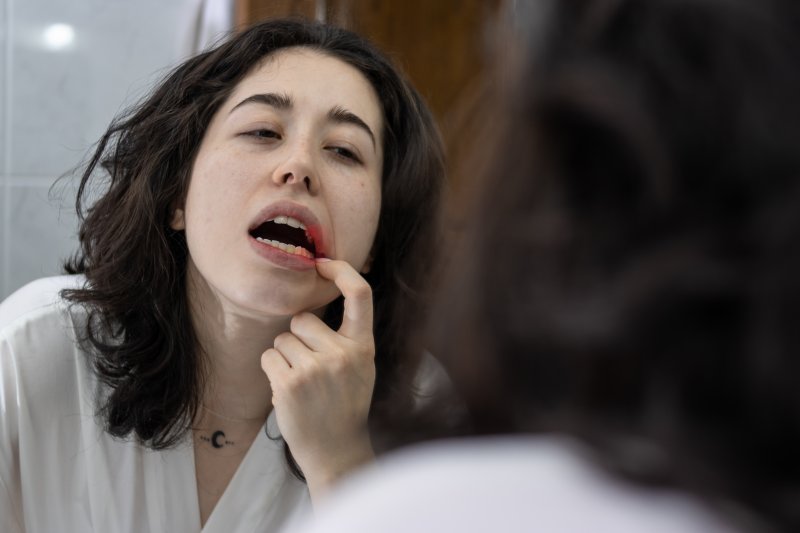 Patient checking their gums for gum disease in the mirror