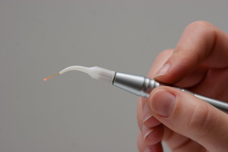 Dentist displaying gum disease laser