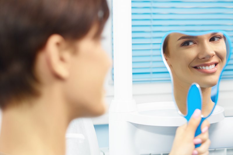 woman smiling in the mirror