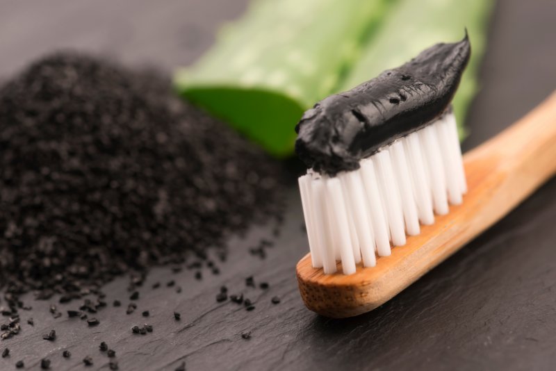 manual toothbrush with charcoal toothpaste