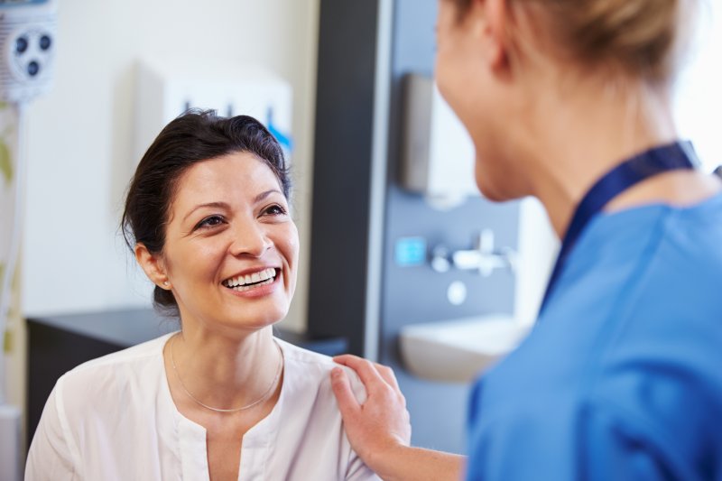 Patient smiling at dentist during appointment